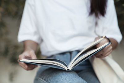 Close-up of woman using mobile phone outdoors