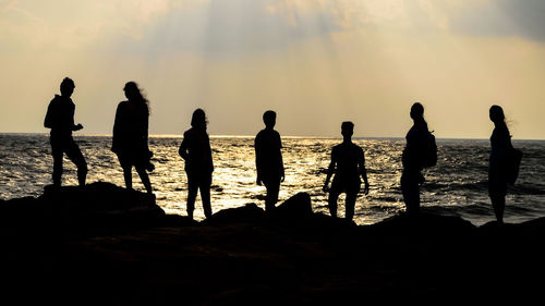 Silhouette of people at sunset