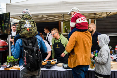 Group of people at market stall