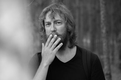 Portrait of man smoking cigarette outdoors