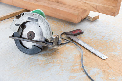 High angle view of circular saw on floor at construction site