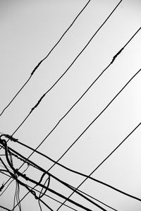 Low angle view of cables against clear sky