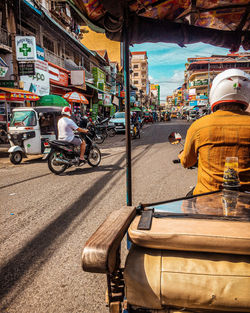 Rear view of people on street in city