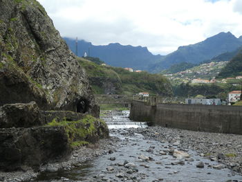 Scenic view of river amidst mountains against sky