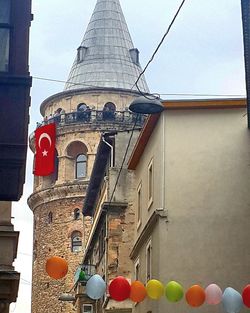 Red structure against sky in city