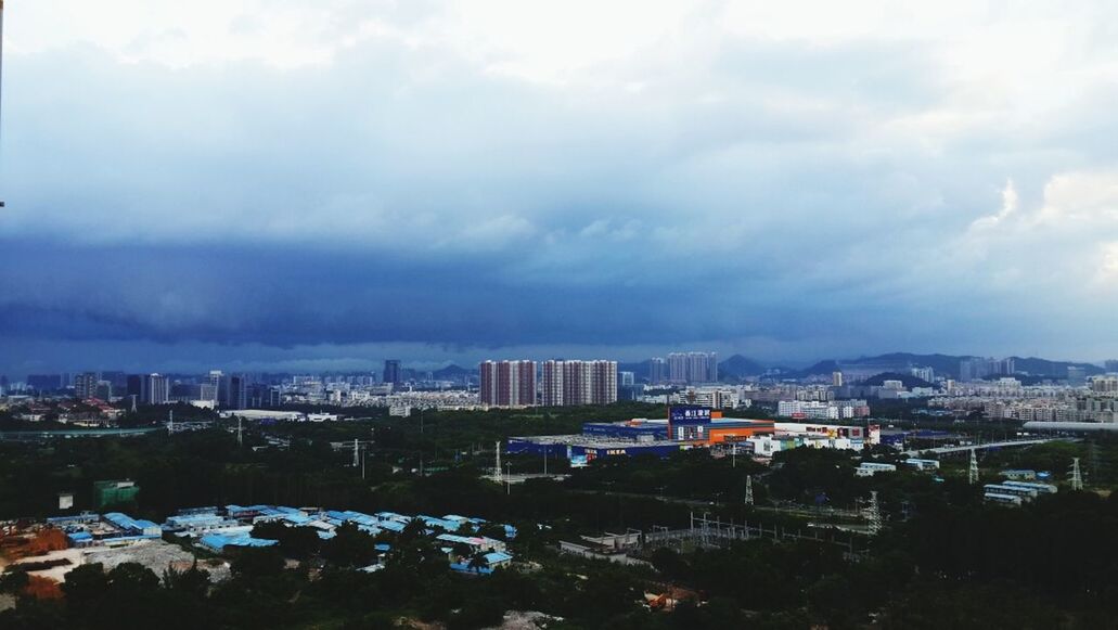 building exterior, architecture, sky, built structure, cloud - sky, city, cloudy, cityscape, residential building, cloud, residential district, residential structure, weather, overcast, high angle view, crowded, outdoors, no people, day, nature