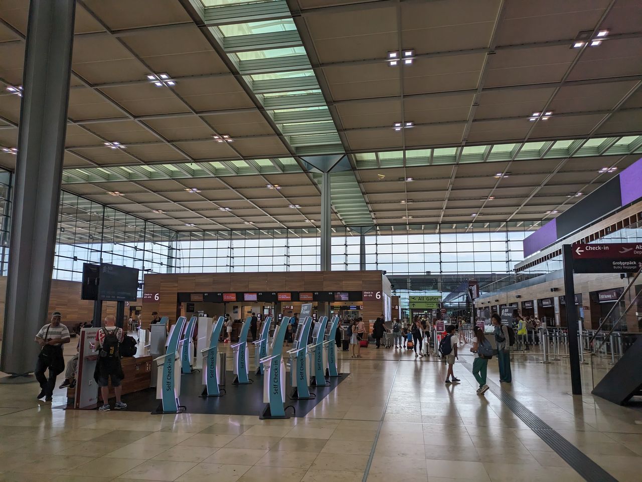 indoors, group of people, large group of people, crowd, airport, building, transport, architecture, airport terminal, adult, men, public transport, travel, business, ceiling, women, business finance and industry, infrastructure, transportation, retail