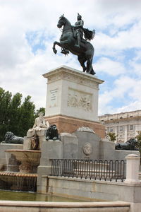 Low angle view of statue against cloudy sky