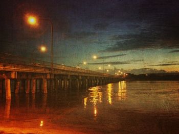 Reflection of illuminated built structure in water at night