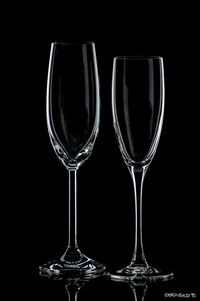 Close-up of wine glasses against black background