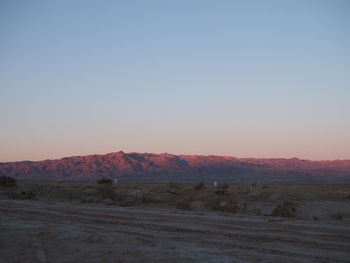 Scenic view of landscape against clear sky during sunset