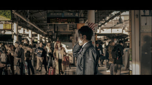 Group of people standing on railroad station platform