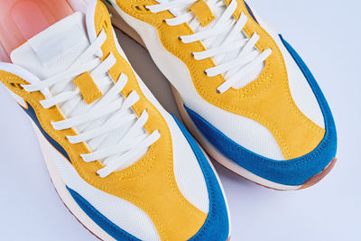Casual sneakers on yellow background, creative minimalism