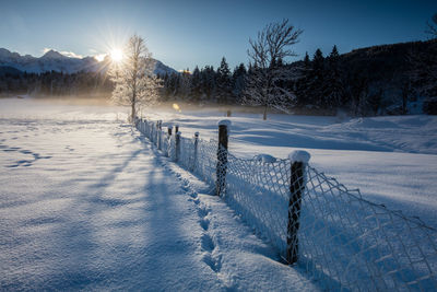 Scenic view of snow field against sky during winter