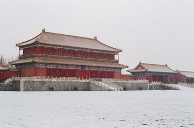 Traditional building against sky during winter