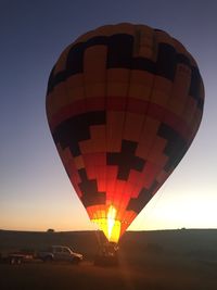 Hot air balloon against clear sky at night