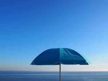 Parasol at beach against sky