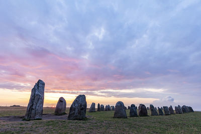 Panoramic shot of rock formations against sky during sunset