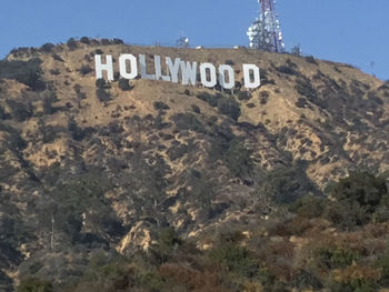 Text on mountain against sky