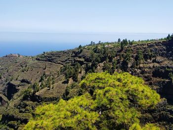 Scenic view of sea and mountain against clear sky