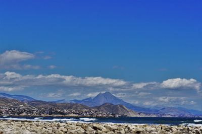 Scenic view of mountains against blue sky