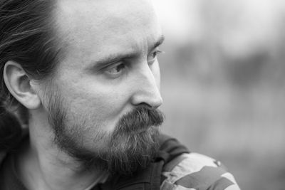 Close-up portrait of man looking away outdoors