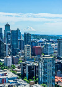 Tall buildings in downtown seattle, washington with mount rainier in the distance