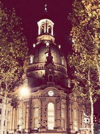 Low angle view of illuminated building against sky at night