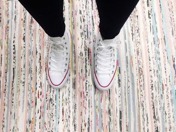 Low section of person standing on carpet