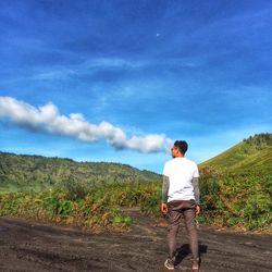 Rear view of man standing on landscape