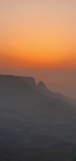 Scenic view of silhouette landscape against sky during sunset