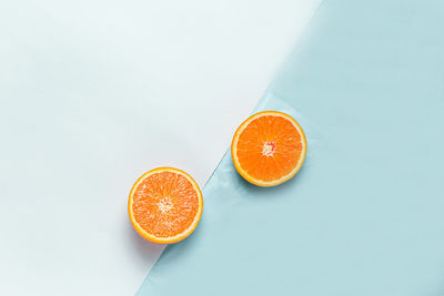 High angle view of orange fruit against white background