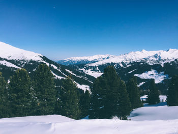 Scenic view of snow covered mountains against clear sky