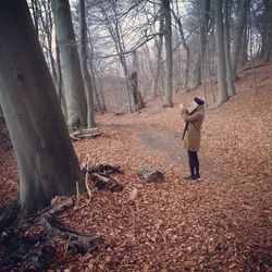 Full length of woman walking in forest