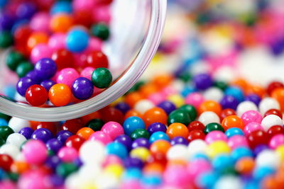 Colorful candies spilling from jar