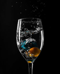 Close-up of wine glass against black background