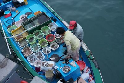 High angle view of fishermen on fishing boat in lake
