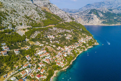 Aerial view of houses in town by sea