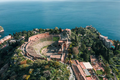 High angle view of buildings and sea in city