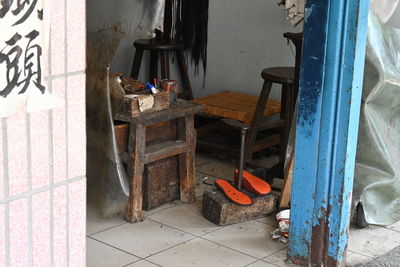 Empty chairs and tables against building