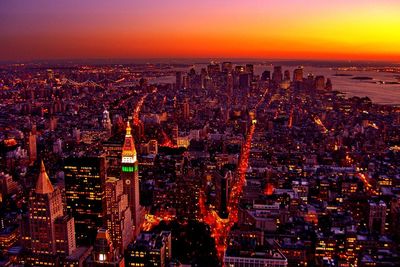 Aerial view of city lit up at sunset