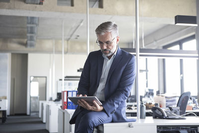 Businessman in office using tablet