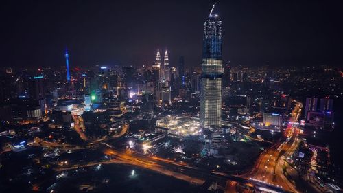 Illuminated modern buildings in city at night