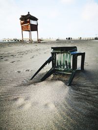 Lifeguard hut on beach against sky