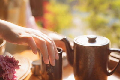 Close-up of hand holding coffee cup