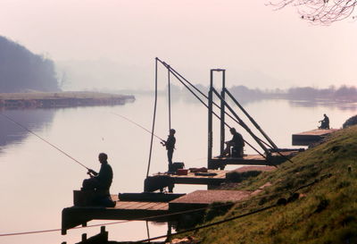 Silhouette of man looking at lake