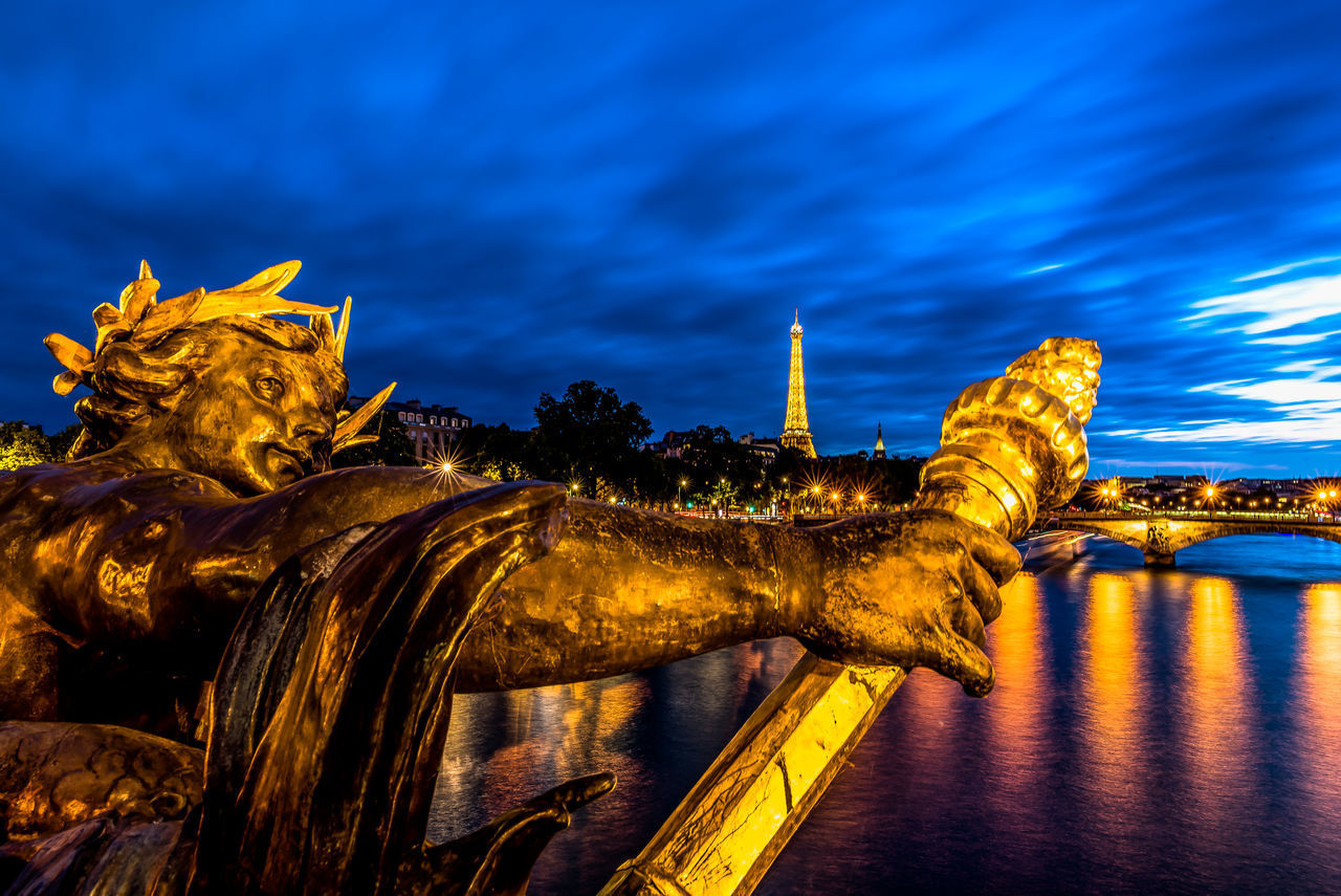 STATUE OF ILLUMINATED LIBERTY AGAINST SKY