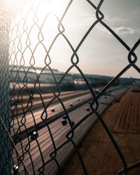 Close-up of chainlink fence against sky