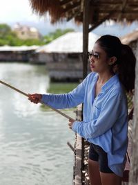 Young woman fishing in sea