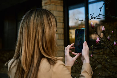 Woman take a photo of flowers